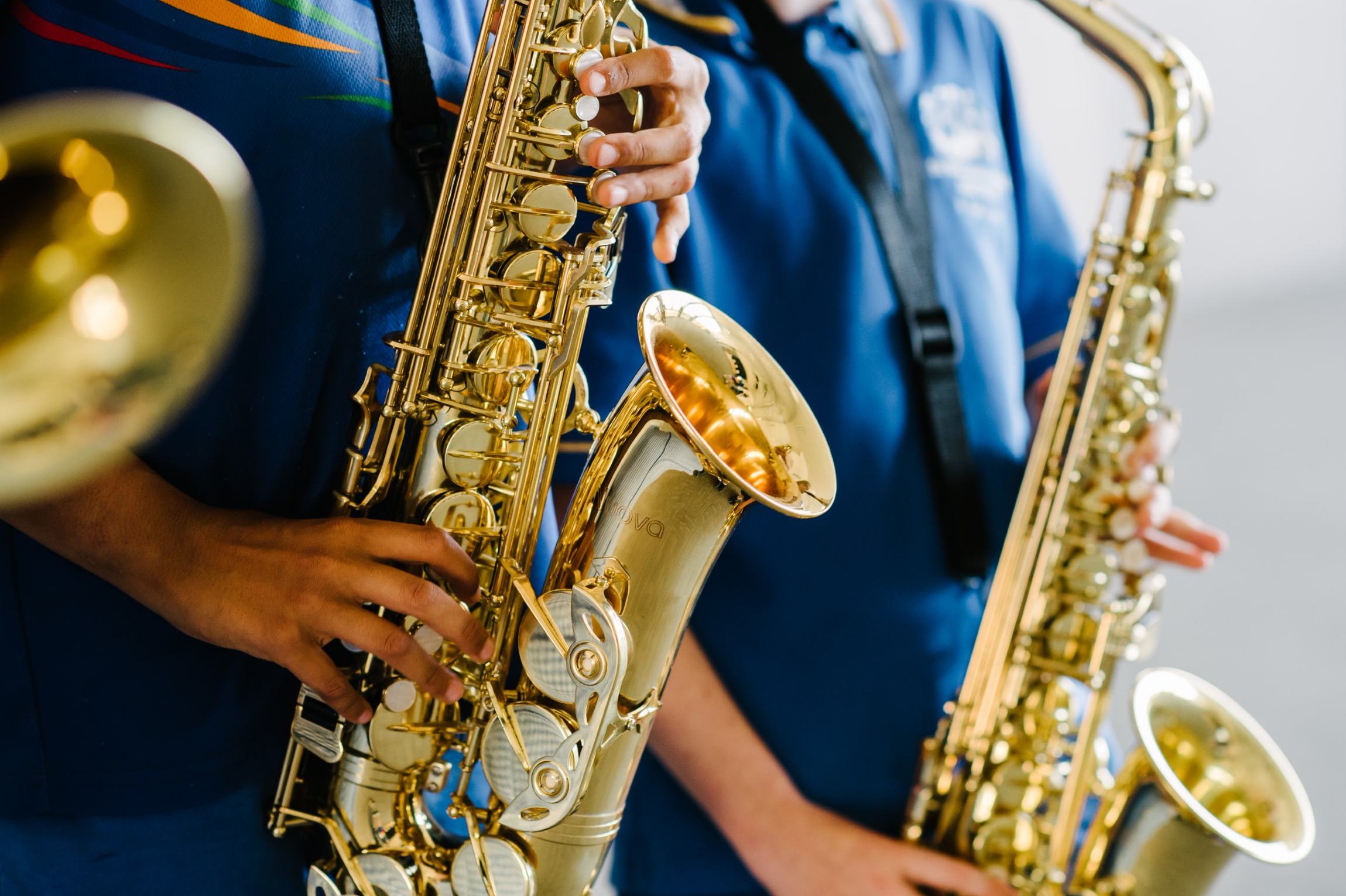 Students holding saxophones during a school music activity.
